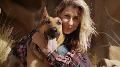 Woman Posing with Dog Outdoors
