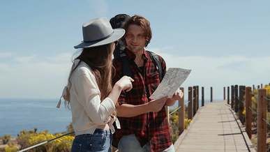 couple talking while holding a map