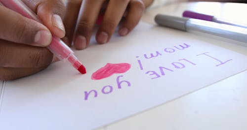 A Kid Writing a Letter to her Mom