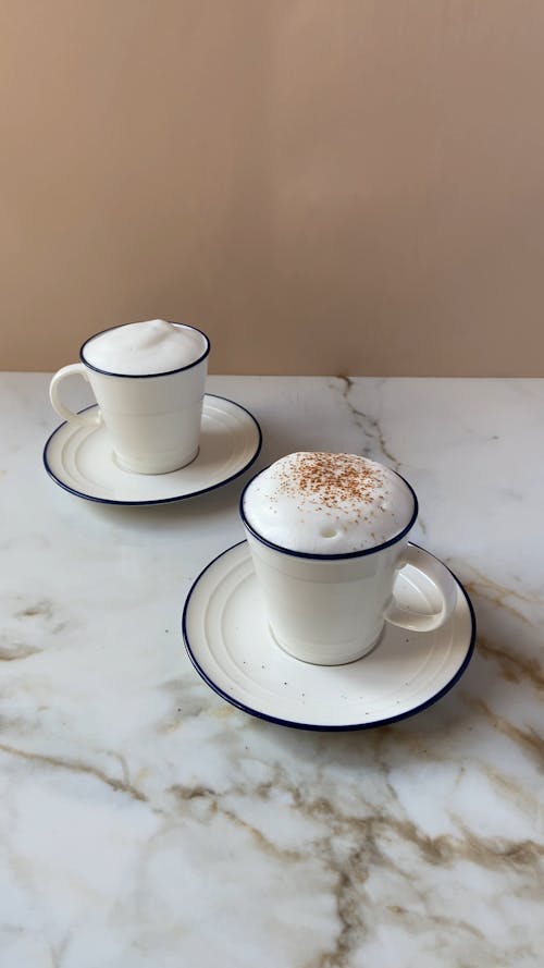 Dusting a Cups of Coffee with Cocoa Powder