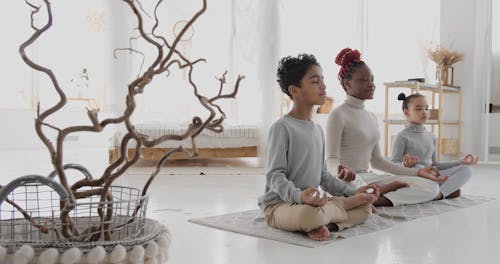 A Family Meditating Indoors
