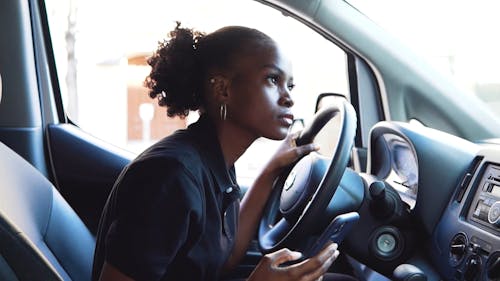 Woman Using a Cellphone Inside the Vehicle