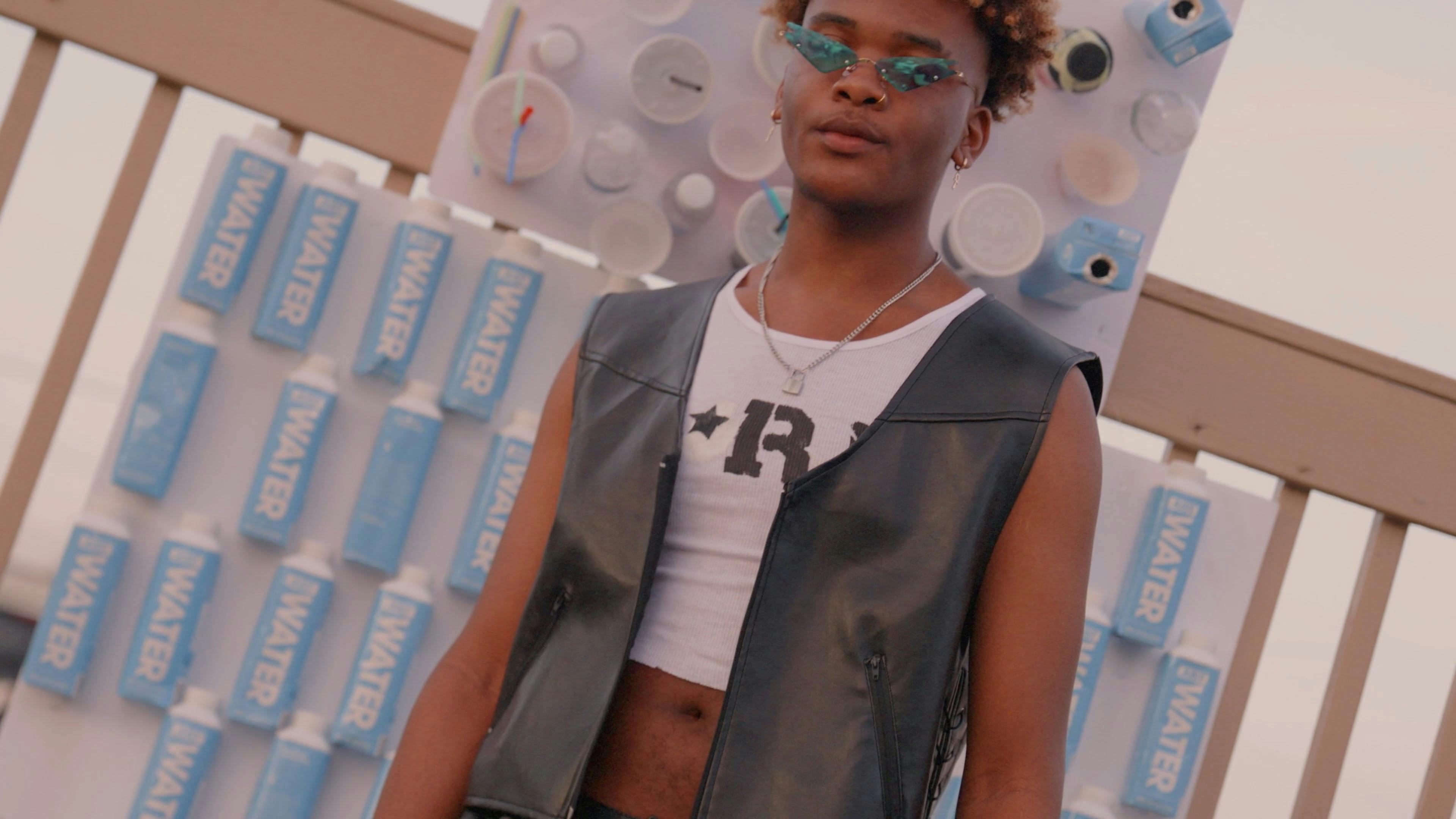 Man Modeling while Looking at Camera with Paper Cups and Plastic