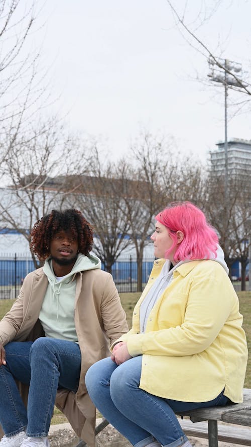 People Sitting on the Bench Having Conversation