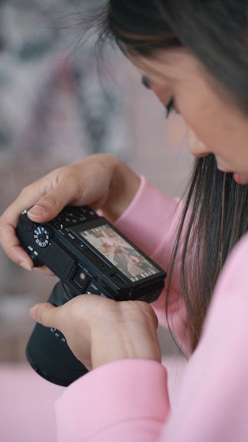 A Young Woman Looking at Pictures on a Digital Camera