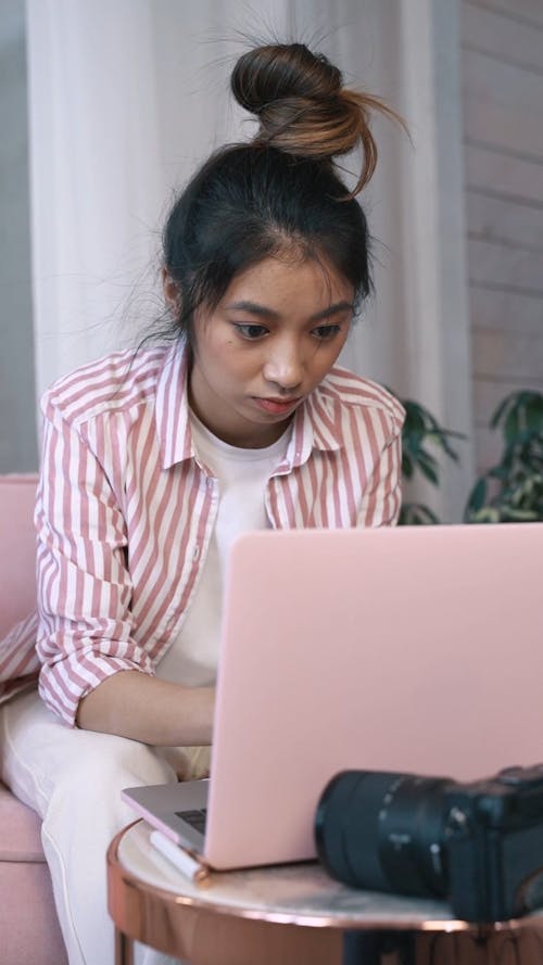 A A Young Woman Focus On Her Work Using A Laptop
