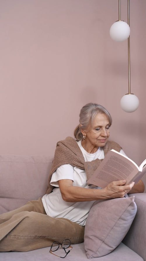 Elderly Woman Reading a Book at Home