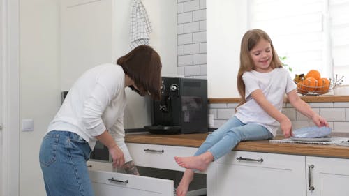 Daughter and Mother Arranging the Plates