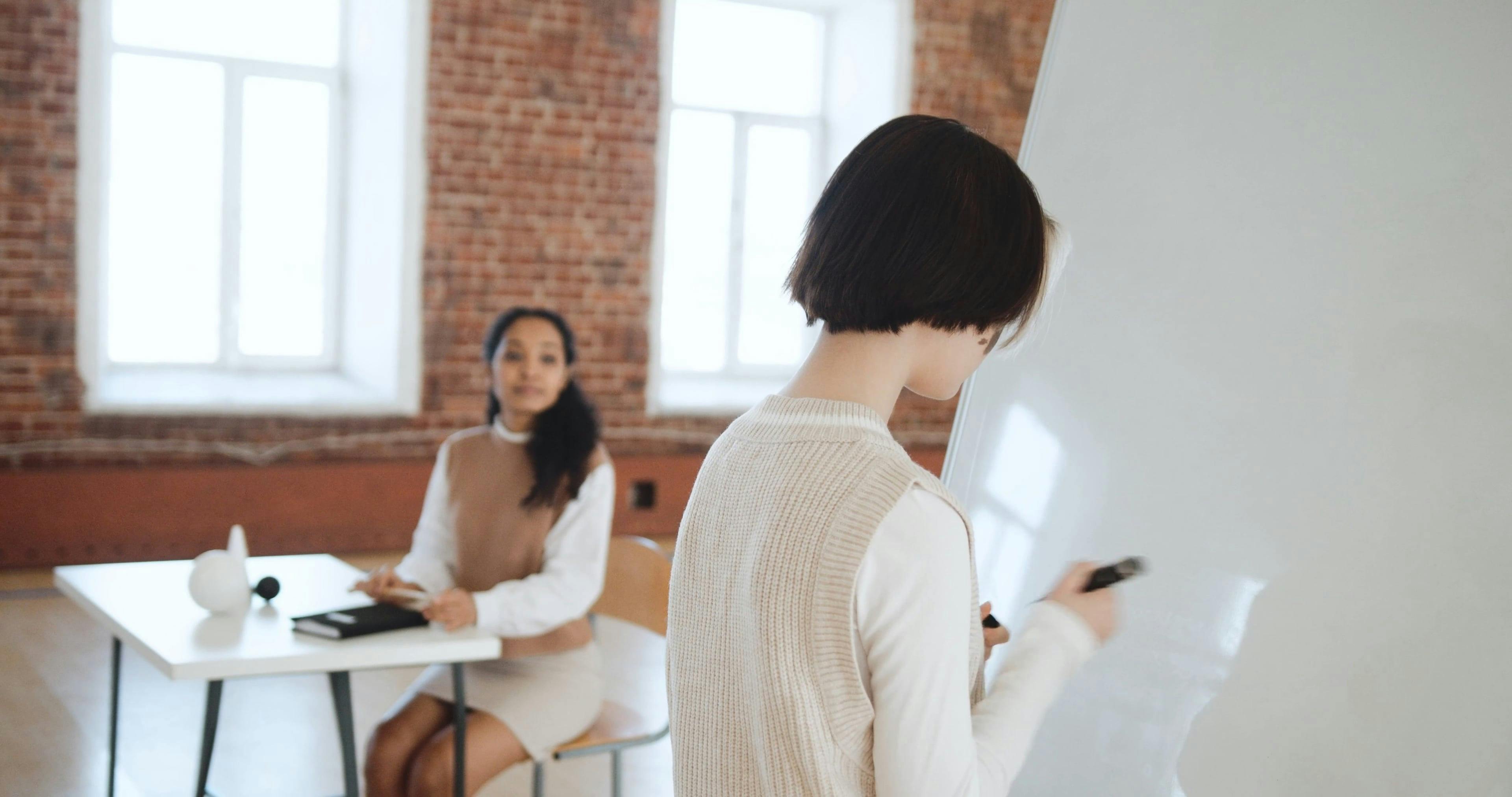 Female Writing a Sentence on the Whiteboard · Free Stock Video