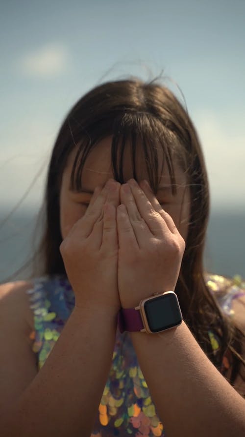 Girl with Down Syndrome Covering her Face