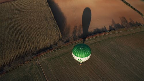 Drone Shot of Hot Air Balloon Flying over Field