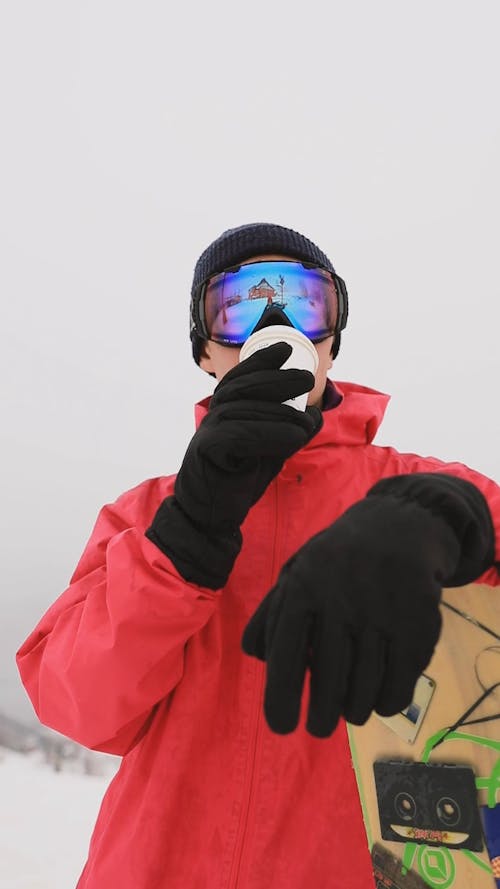 Man Drinking Coffee at a Ski Resort