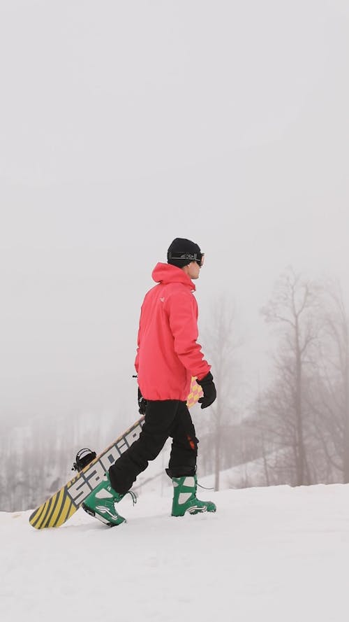 Man Walking with his Snowboard