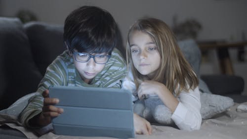 Siblings Using a Tablet