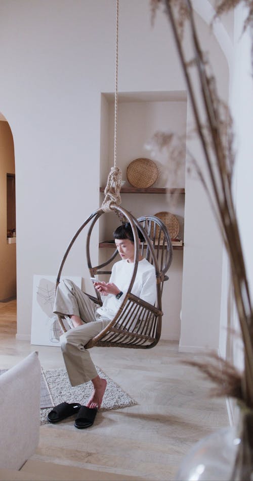 Using Phone while Sitting on a Hanging Chair