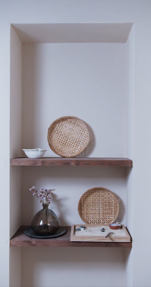 A Person Placing Vases on a Shelf