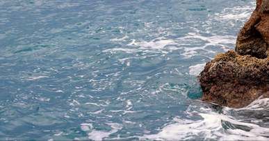 video of waves crashing on a rock