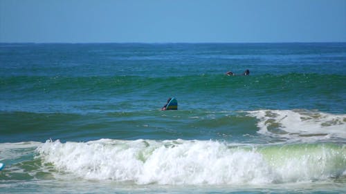 People Surfing in the Ocean