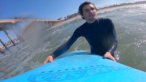 A Man Paddling Out on Surfboard 