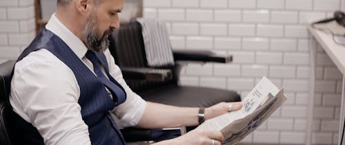 Businessman Reading a Newspaper at the Barbershop