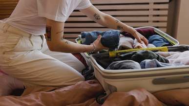 a person packing clothes