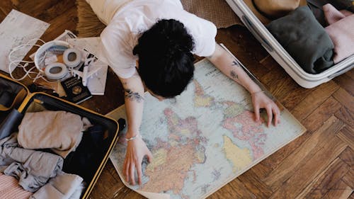 A Woman Looking at a World Map