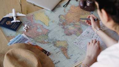 a person pointing on a world map
