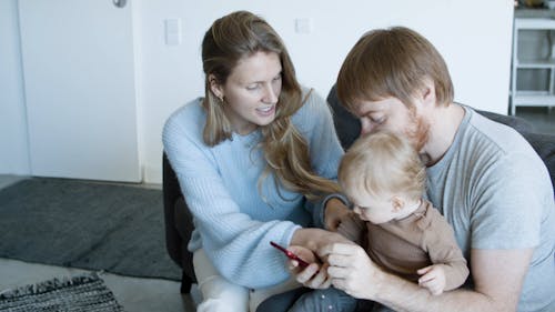 Parents Taking Care of Their Daughter