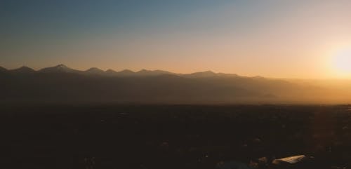 An Aerial Footage of a Landscape During Golden Hour