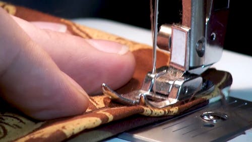 Close-Up Video of a Person Using a Sewing Machine