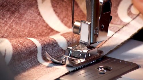 Close-Up Video of a Person Using a Sewing Machine