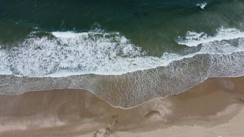 Aerial Footage of Waves Crashing on Shore