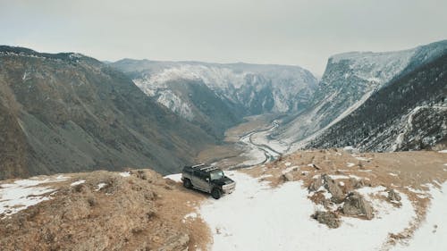 Car on Top of a Snow Covered Mountain