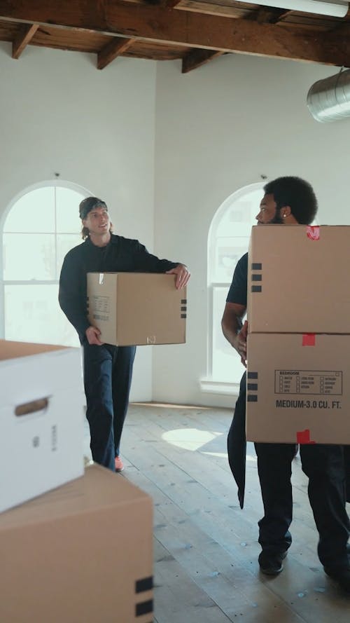 Men Bringing Boxes while Walking and Talking