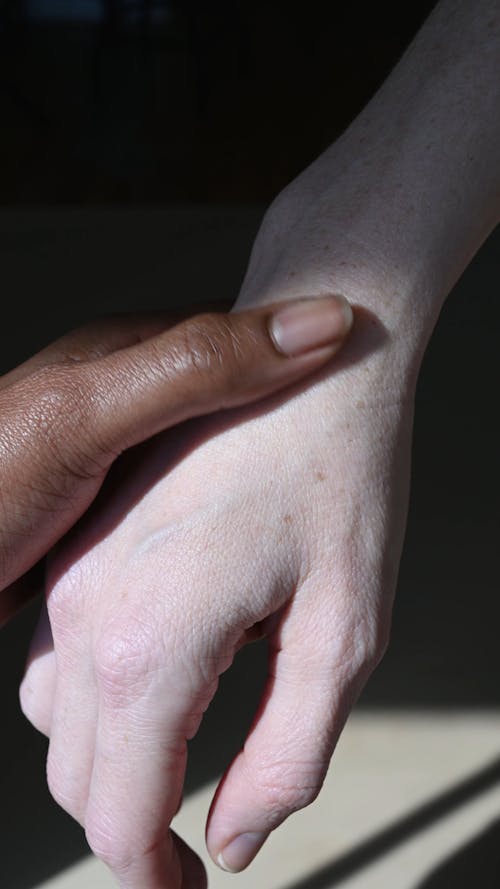 Person Touching Another Person's Hand