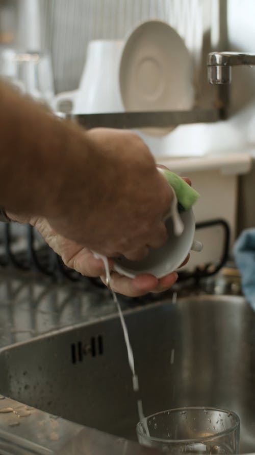 Person Washing and Cleaning a Cup