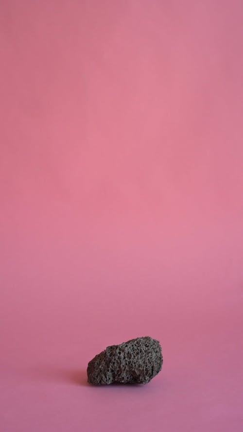 A Rock on Light Pink Background