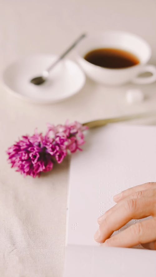 A Person Reading a Braille Book