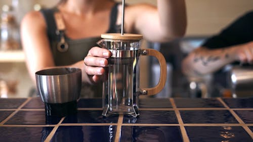 Close-Up Video of Barista Putting Freshly Groudn Coffee on a French Press