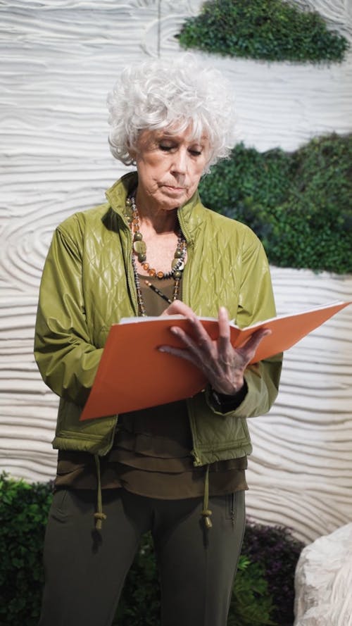 An Elderly Woman Taking Notes