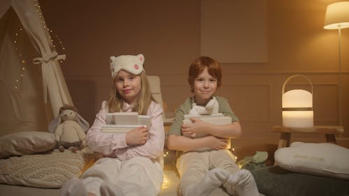 Children Sitting on the Floor while Holding Books