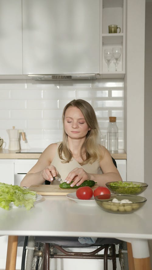 Disabled Woman Slicing the Cucumber