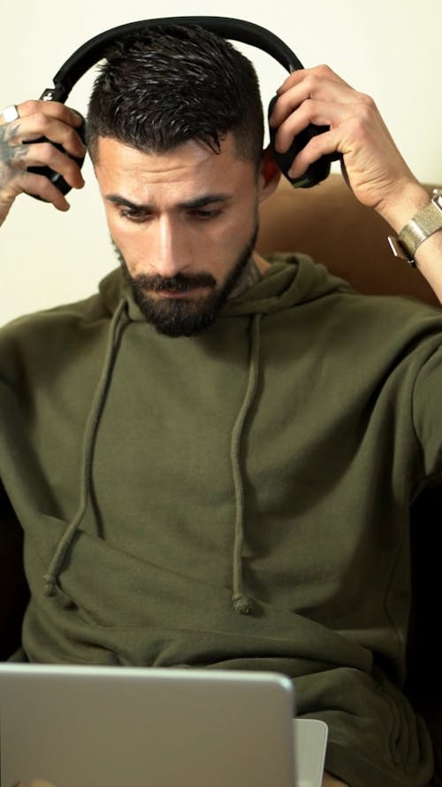 Man Putting on Headphones