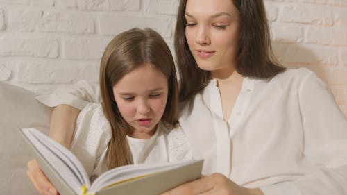 Mom and Daughter Reading a Book Together