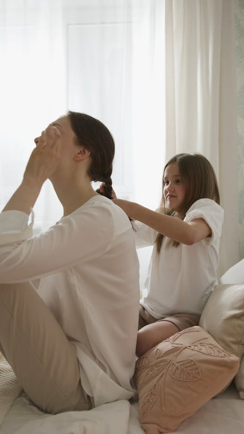 A Child Braiding Her Mom