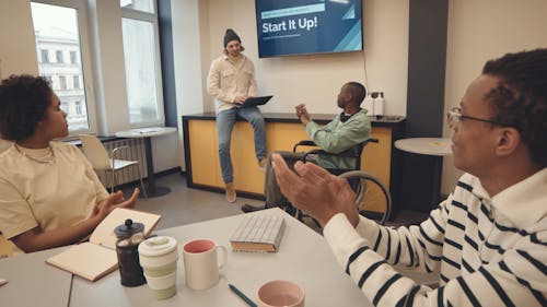 Company Employees Applauding Their Colleague