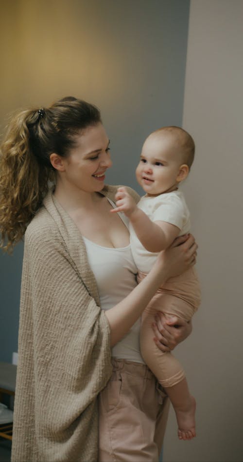 Mother Putting the Baby in Crib