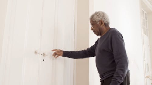 Elderly Man Opening a Door