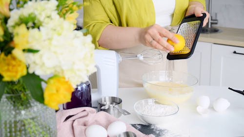 A Woman Grating Lemon into the Batter