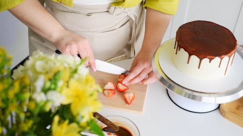 A Woman Slicing Strawberries
